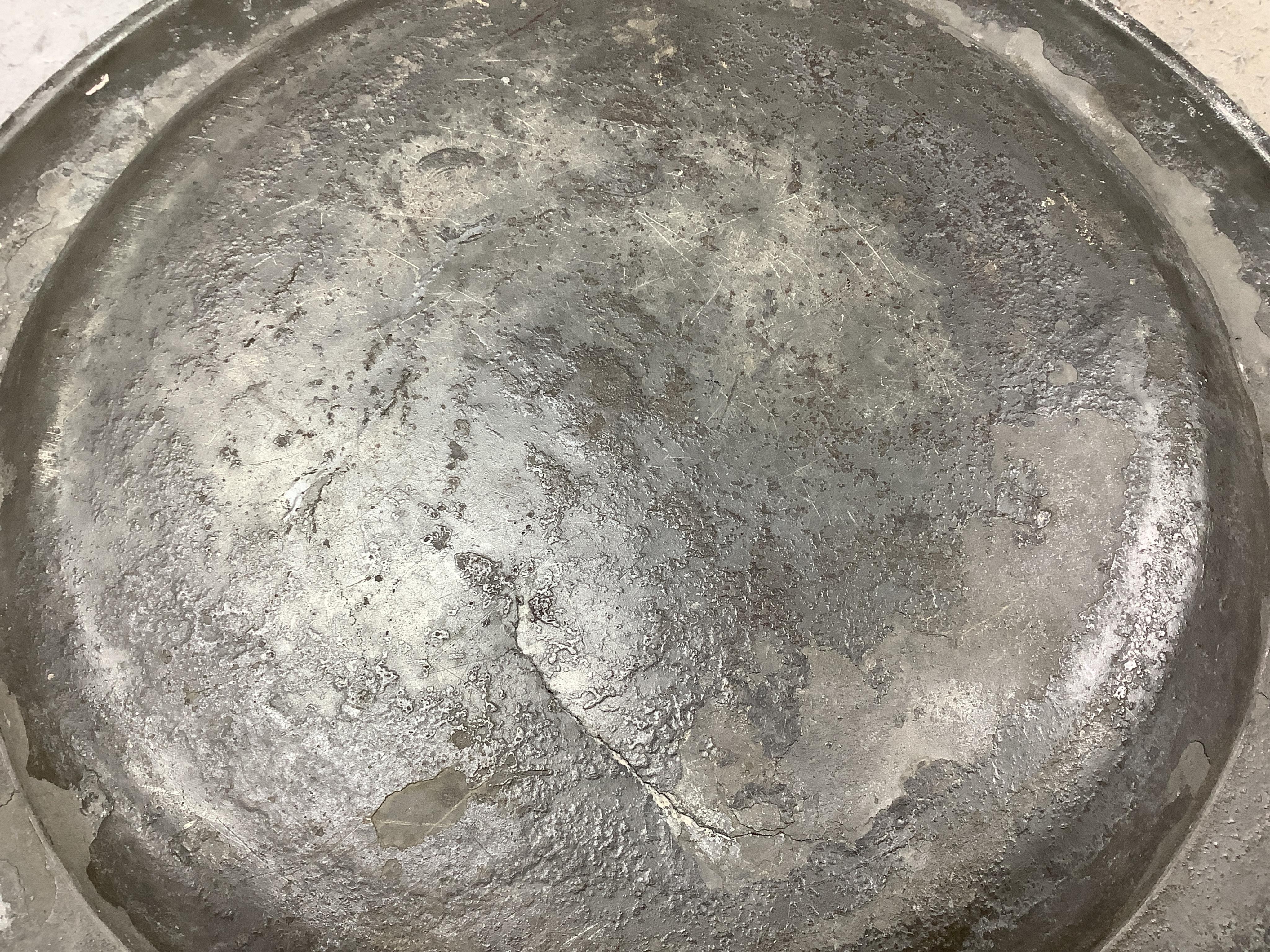 Three pewter chargers, a London touch mark to one, another with rubbed touch marks and ‘WRM’, and another with remains of a touch mark, largest 42.5cm diameter. Condition - fair, worn with damage to one